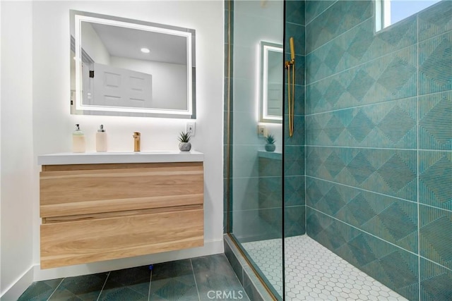 bathroom featuring vanity, tile patterned floors, and a tile shower