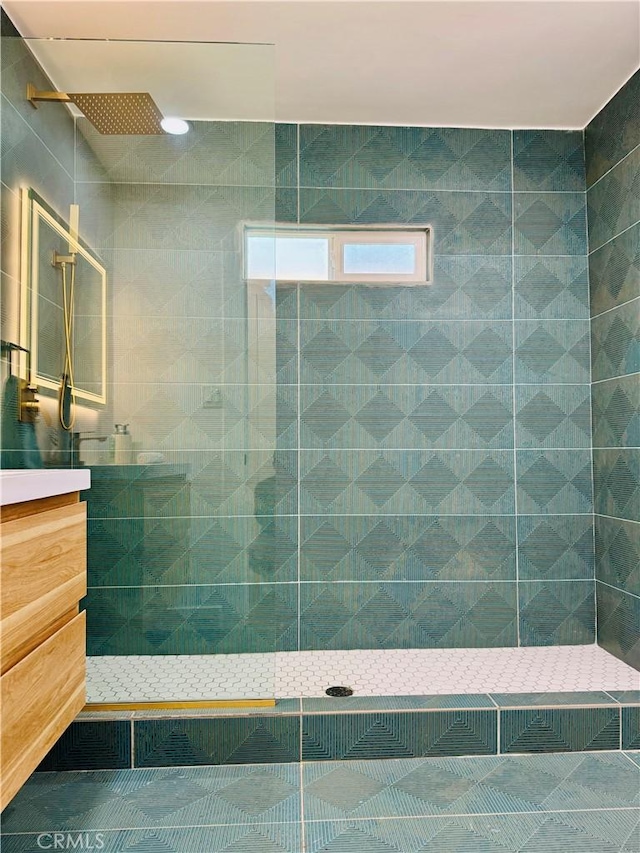 bathroom featuring walk in shower, vanity, and tile patterned flooring