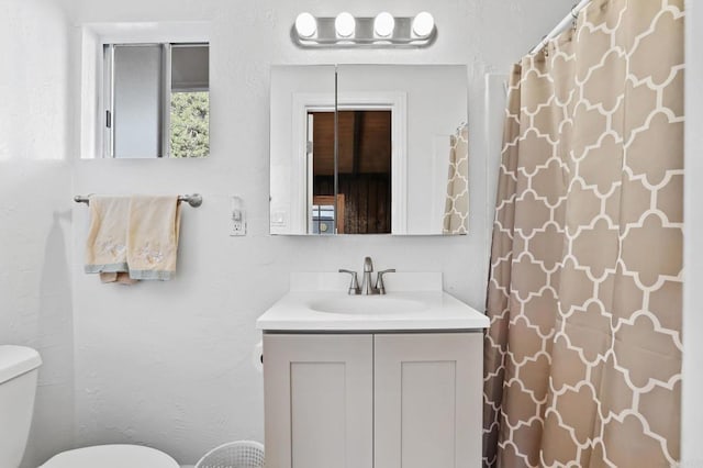 bathroom featuring toilet and vanity