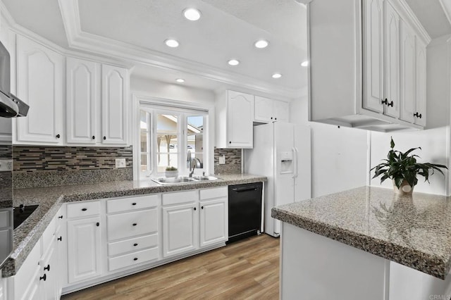 kitchen featuring tasteful backsplash, dishwasher, white refrigerator with ice dispenser, white cabinets, and sink