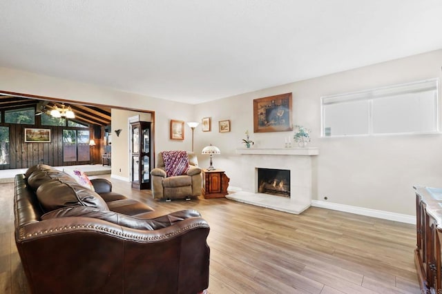 living room featuring lofted ceiling and light wood-type flooring