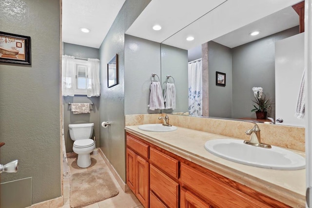 bathroom featuring toilet, tile patterned flooring, and vanity