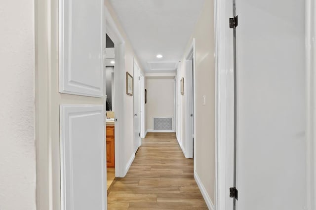 corridor with light hardwood / wood-style floors