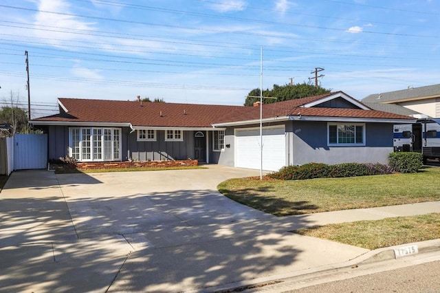 single story home with a garage and a front lawn