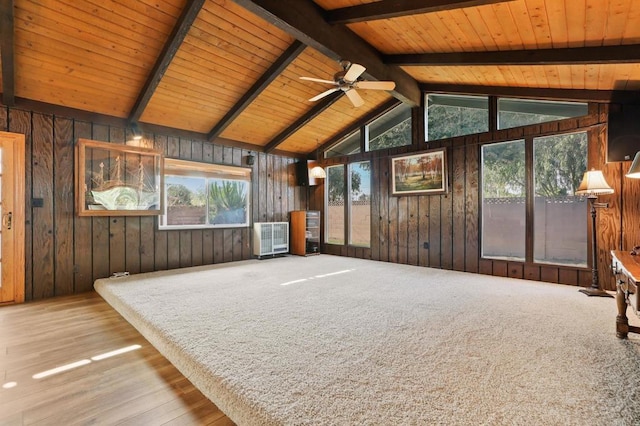 interior space featuring wooden ceiling, a healthy amount of sunlight, and vaulted ceiling with beams