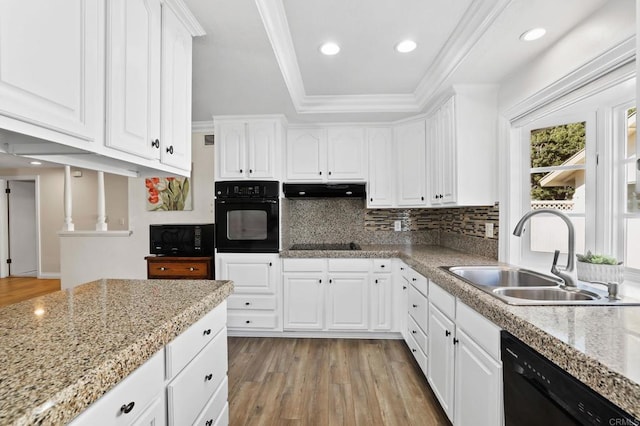 kitchen featuring light wood-type flooring, sink, white cabinets, and black appliances