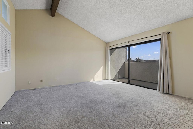 empty room featuring a textured ceiling, carpet flooring, and vaulted ceiling with beams