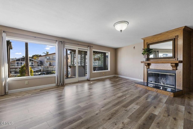 unfurnished living room with hardwood / wood-style flooring and a fireplace