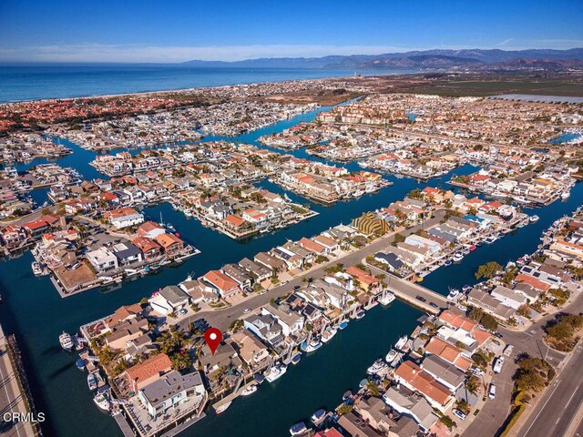 drone / aerial view featuring a water and mountain view