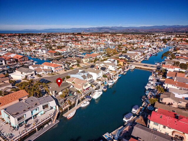 drone / aerial view featuring a water and mountain view