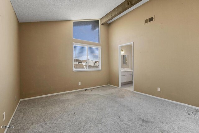 unfurnished room with high vaulted ceiling, a textured ceiling, light carpet, and beamed ceiling