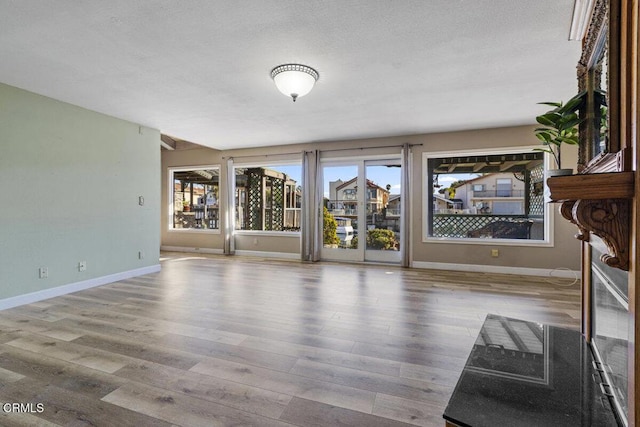 unfurnished living room with light wood-type flooring