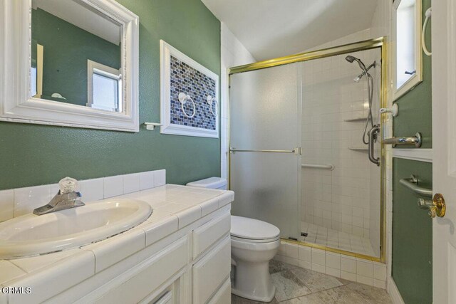 bathroom featuring vanity, toilet, tile patterned floors, and a shower with door