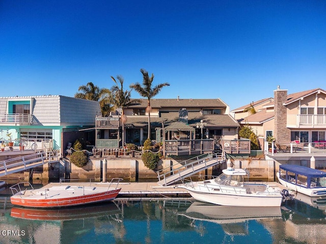 view of swimming pool featuring a water view and a dock