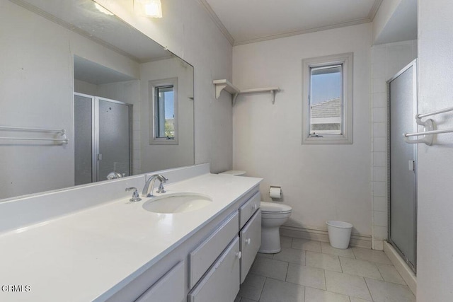 bathroom featuring toilet, vanity, tile patterned floors, crown molding, and an enclosed shower