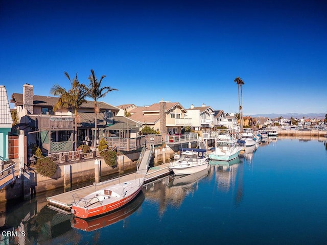 view of dock with a water view and a residential view