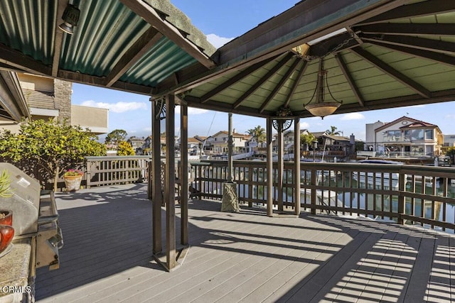 deck with a residential view and a grill