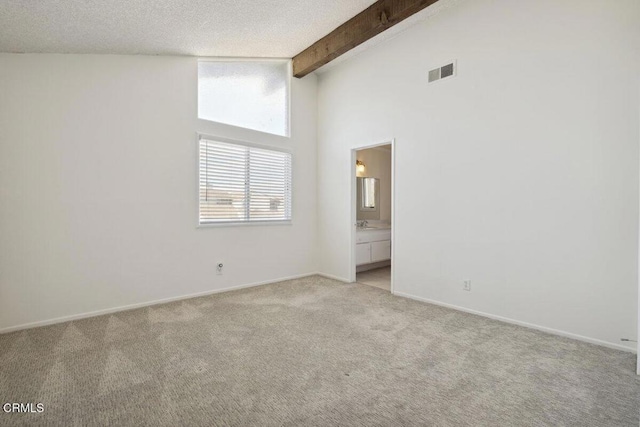 spare room featuring high vaulted ceiling, beamed ceiling, light colored carpet, visible vents, and baseboards