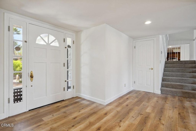 entrance foyer with recessed lighting, stairway, light wood-style floors, and baseboards
