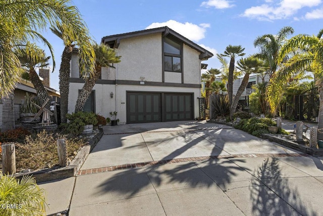 view of front of house featuring an attached garage, driveway, and stucco siding