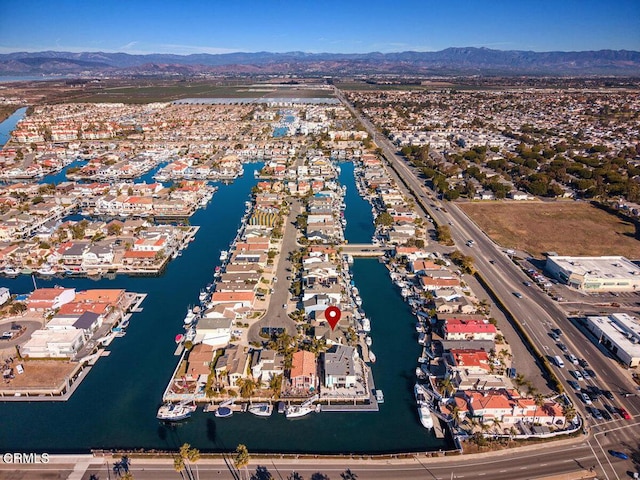 birds eye view of property featuring a water and mountain view and a residential view