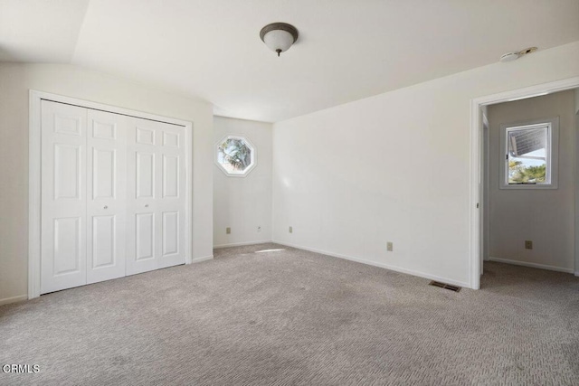 unfurnished bedroom with visible vents, baseboards, and carpet