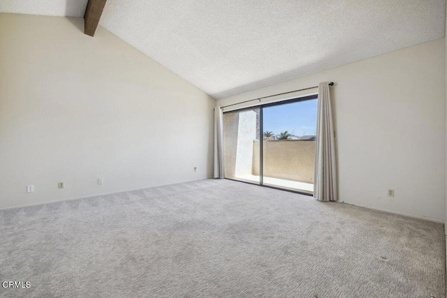 unfurnished room with carpet flooring, a textured ceiling, and vaulted ceiling with beams