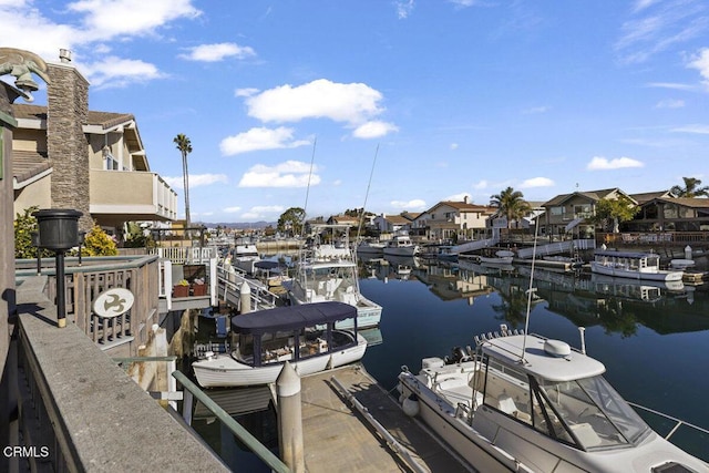 dock area featuring a water view and a residential view