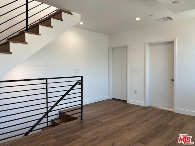 stairway with hardwood / wood-style flooring