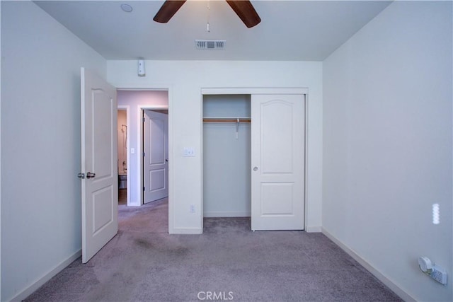 unfurnished bedroom with baseboards, visible vents, light colored carpet, ceiling fan, and a closet