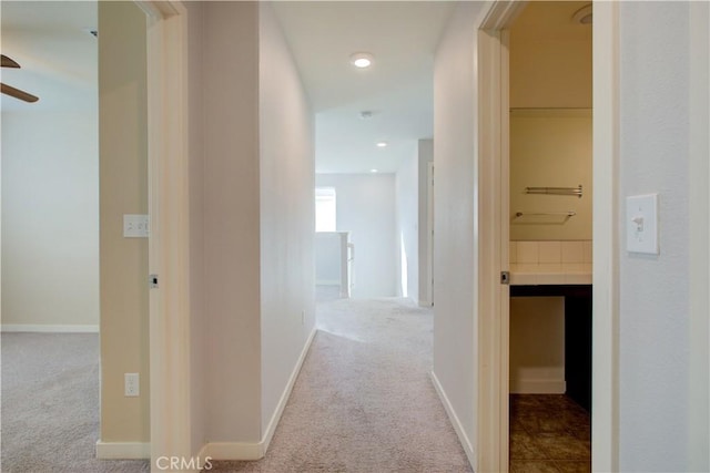 hall featuring recessed lighting, light colored carpet, and baseboards