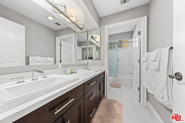 full bathroom featuring toilet, vanity, and shower / bath combination with glass door