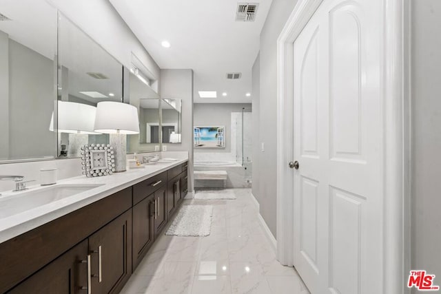 bathroom with vanity and separate shower and tub