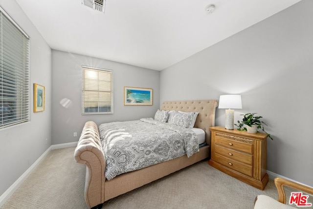 bedroom featuring light carpet