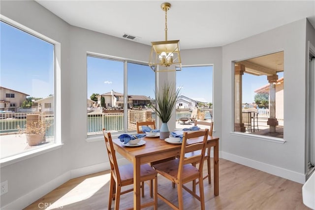 dining area with a chandelier and light hardwood / wood-style floors