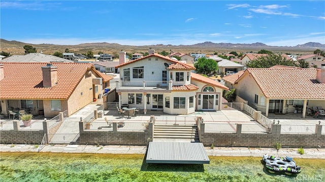 back of house featuring a mountain view and a balcony