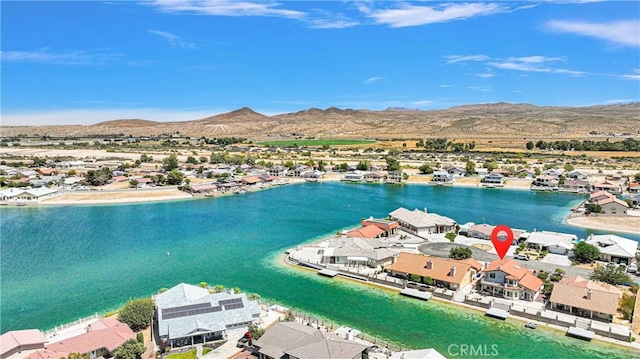 birds eye view of property with a water and mountain view