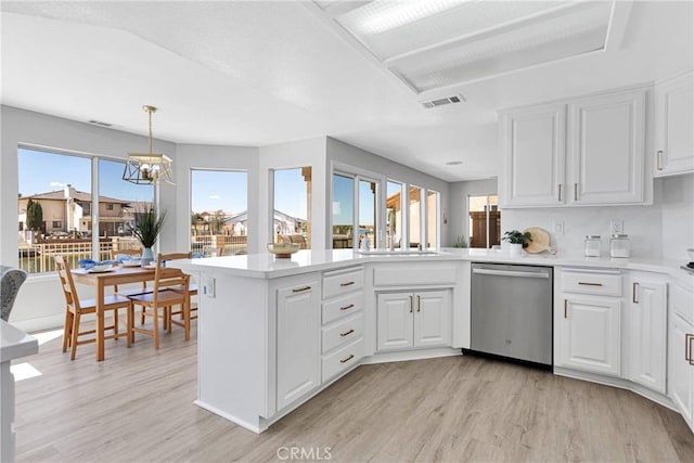 kitchen with dishwasher, decorative light fixtures, white cabinetry, light hardwood / wood-style floors, and kitchen peninsula