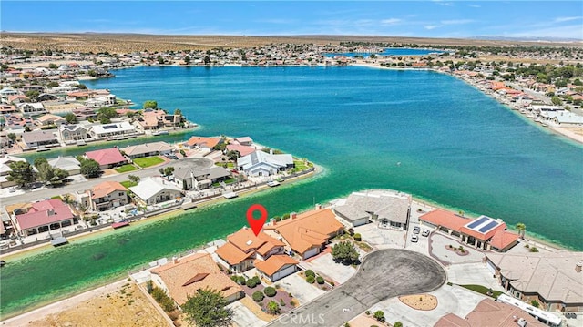 drone / aerial view featuring a water view and a view of the beach