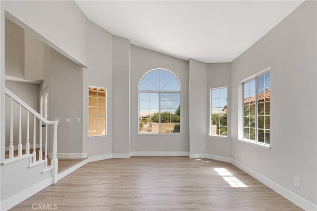 spare room featuring a wealth of natural light and light hardwood / wood-style flooring