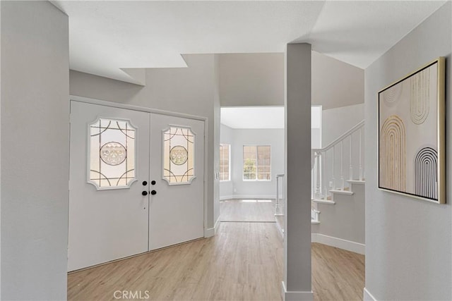 entrance foyer featuring light wood-type flooring and french doors