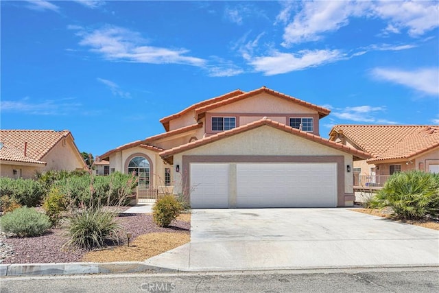 mediterranean / spanish-style home with a garage