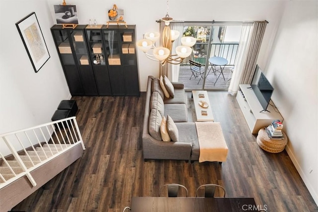 living room with dark hardwood / wood-style floors and a chandelier