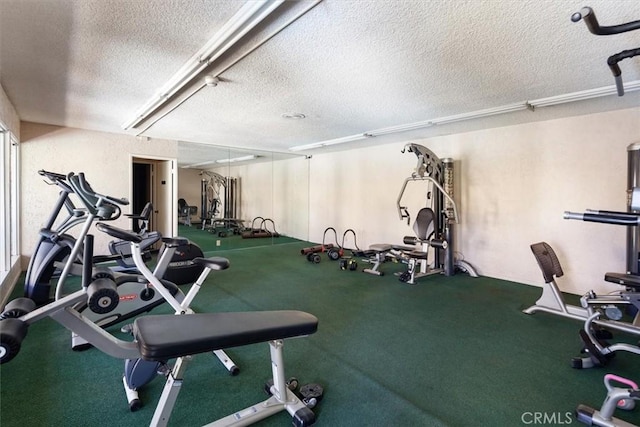 exercise room featuring a textured ceiling