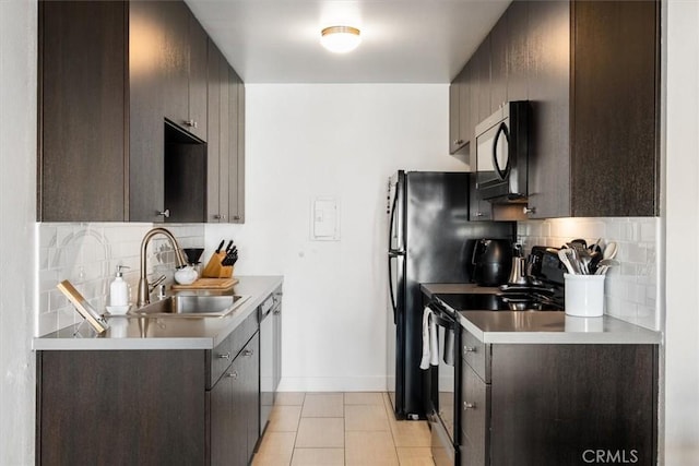 kitchen featuring sink, backsplash, dark brown cabinetry, and black appliances