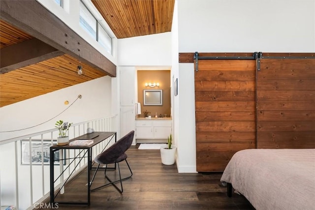 bedroom with ensuite bath, dark wood-type flooring, high vaulted ceiling, wooden ceiling, and a barn door