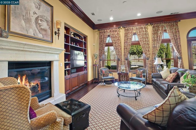 living room featuring ornamental molding, hardwood / wood-style floors, and built in shelves