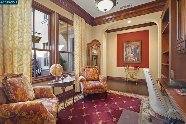 living area featuring dark wood-type flooring, built in features, and crown molding