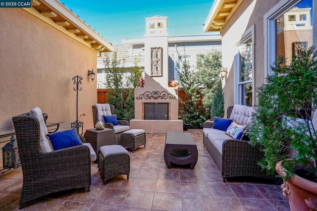 view of patio featuring an outdoor living space with a fireplace