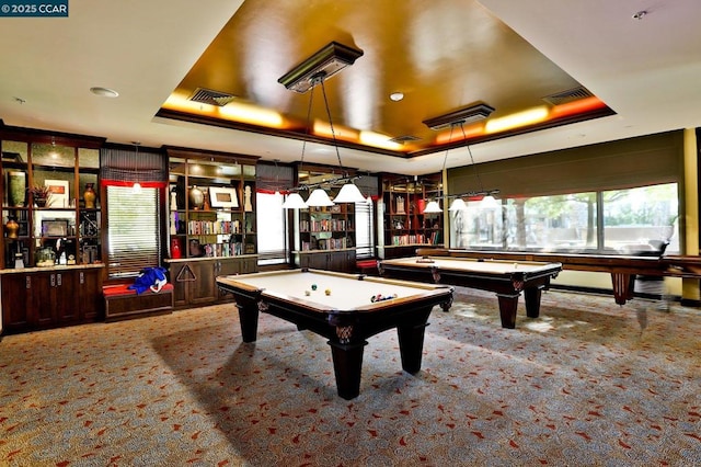 game room featuring billiards, a raised ceiling, and light carpet